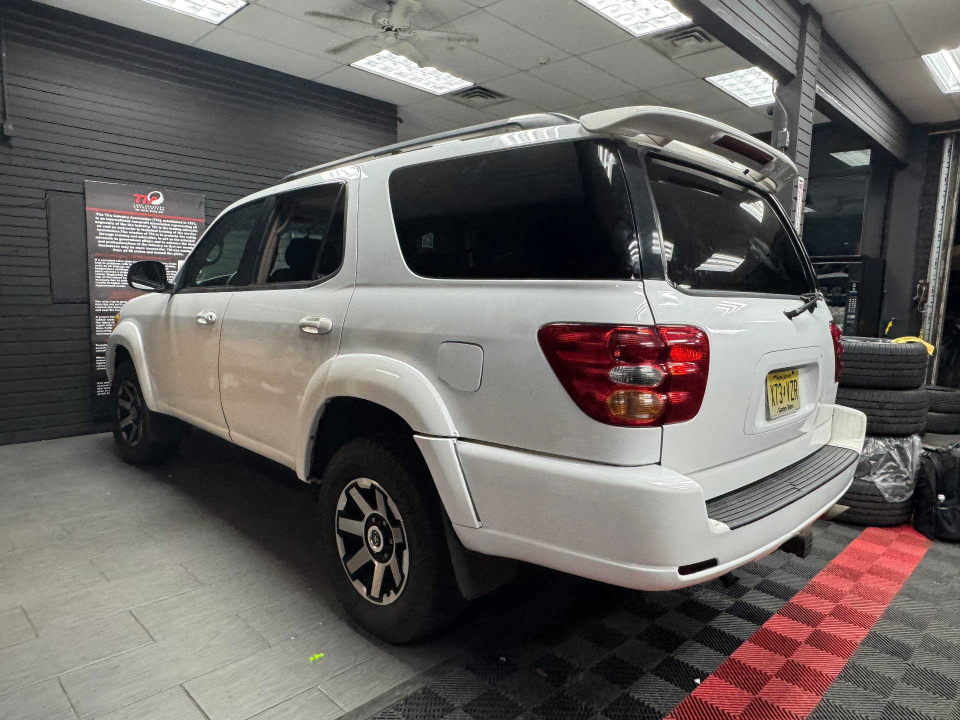 White SUV in a wrap shop with color change film applied