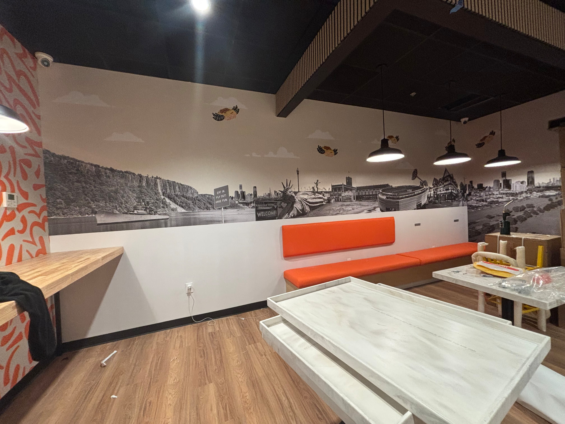 Black and white panoramic cityscape wall mural in a restaurant interior