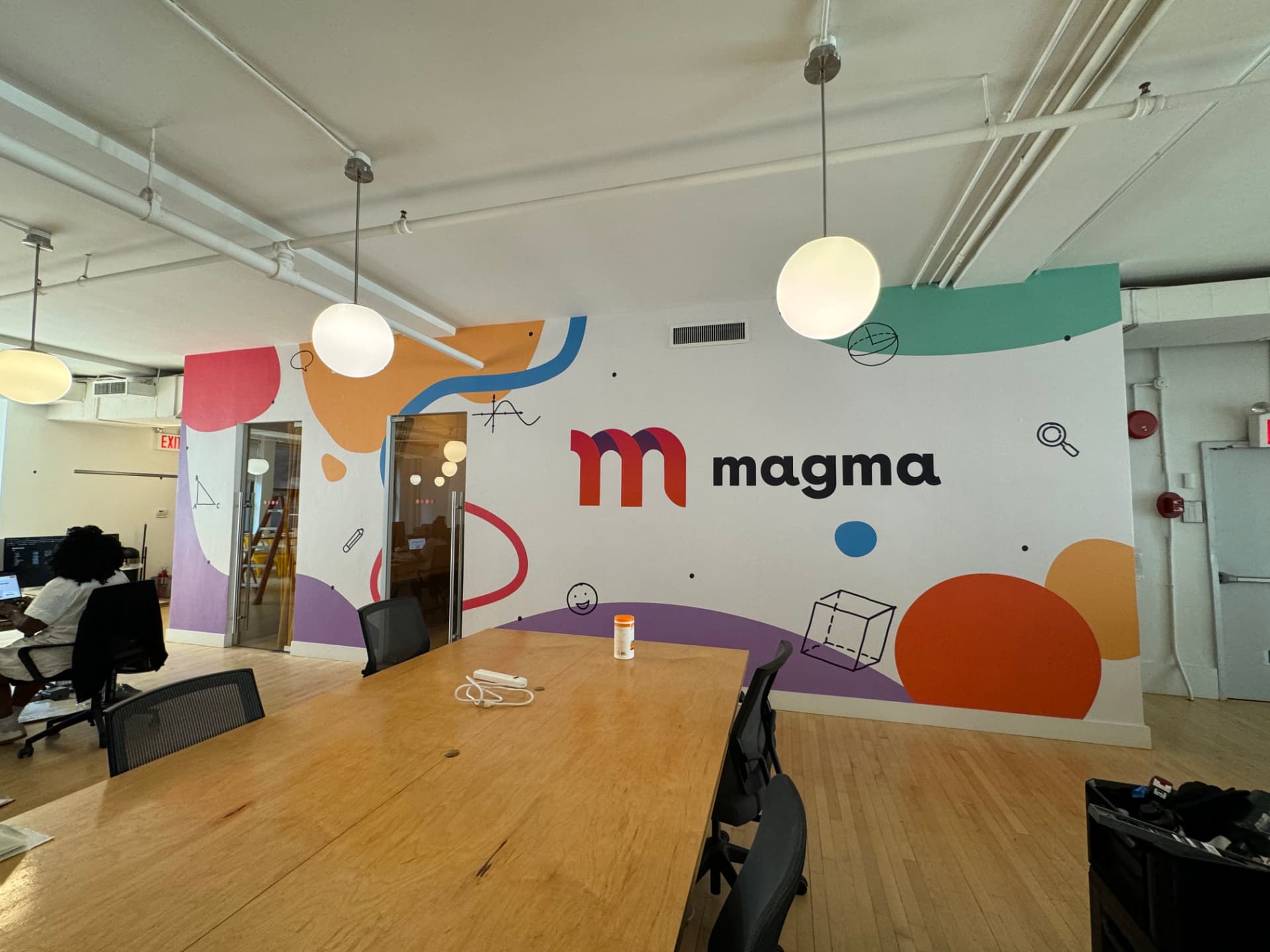 Colorful branded office wall mural for Magma with geometric shapes and logo