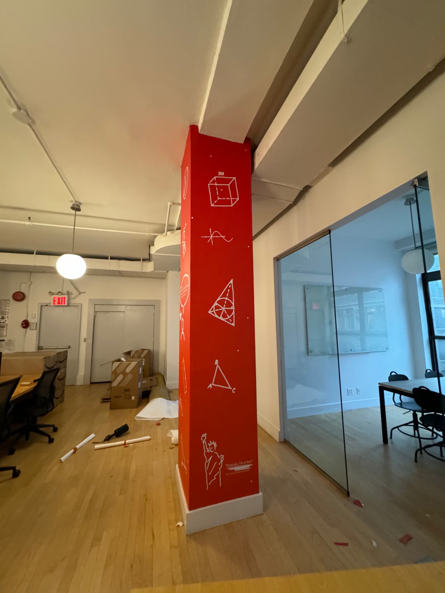 Red printed vinyl column graphics with white line illustrations in an office